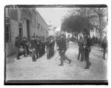 "D. Carlos seguido do comandante da Escola do Exército a entrar no edifício para assistir à abertura dos trabalhos escolares".