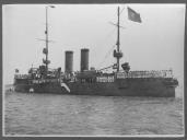 Vista lateral do navio com a bandeira hasteada.